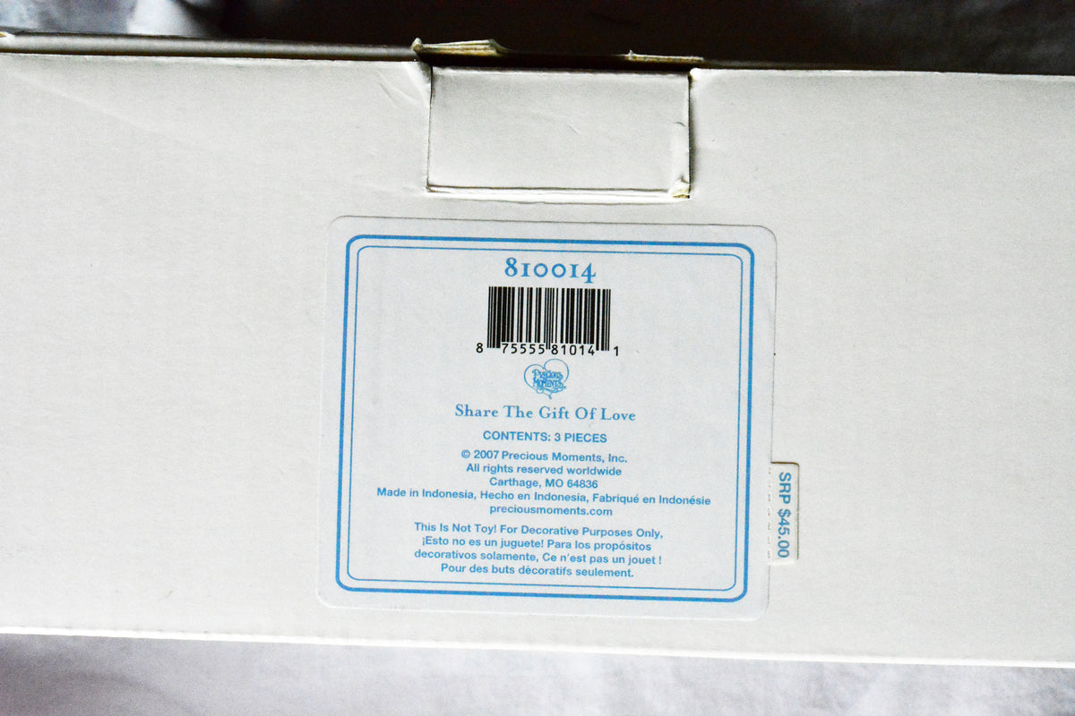 Back of Precious Moments Come Let Us Adore Him three-piece nativity set box titled Share The Gift Of Love